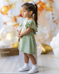 Load image into Gallery viewer, mace and co dubai kids linen material dress in mint green colour, open back design with frill sleeve, for girls, perfect for casual wear, special occasions and parties.
